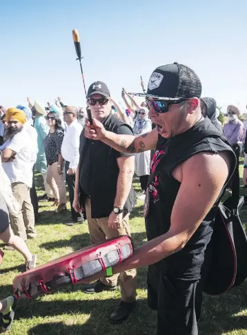  ?? DARRYL DYCK / THE CANADIAN PRESS ?? William George, a member of the Tsleil-Waututh First Nation, was among anti-pipeline protesters voicing their opposition as Prime Minister Justin Trudeau spoke at a Liberal party barbecue in Delta, B.C., on Sunday.