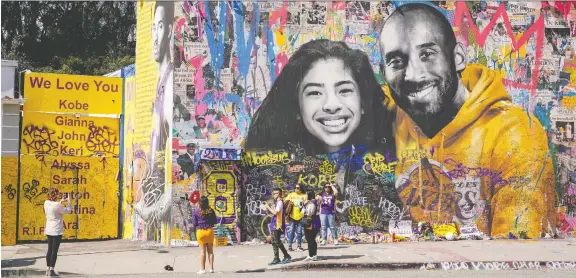  ?? KYLE GRILLOT/ REUTERS ?? Fans gather around a mural of NBA great Kobe Bryant and his daughter Gianna Bryant in late February during a public memorial at the Staples Center in Los Angeles. The star's Jan. 26 sudden death kicked off a year in sports that would see numerous legendary athletes die, including Eddie Shack and Toronto Blue Jays great Tony Fernandez.