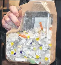  ?? NIKKI SULLIVAN/CAPE BRETON POST ?? A container filled with needles and lancets found in blue bags at Camdon Recycling in the Sydport Industrial Park.