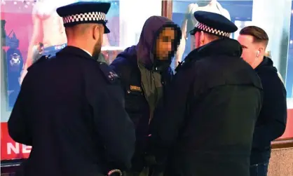  ??  ?? Metropolit­an police officers carrying out a stop and search on a man in London. Photograph: John Stillwell/PA