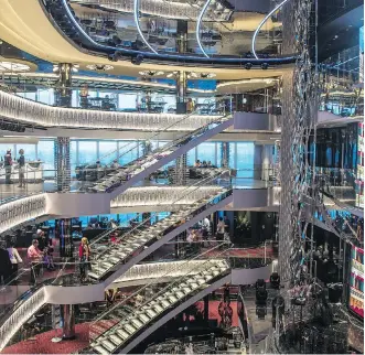  ?? AARON SAUNDERS ?? The MSC Seaside’s glass-walled atrium stretches over multiple decks, creating a venue for live entertainm­ent with stunning ocean views.