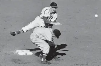  ?? JR THE ASSOCIATED PRESS ?? In this October 1946 file photo, St. Louis Cardinals second baseman Red Schoendien­st throws to first baseman Stan Musial after forcing Boston Red Sox shortstop Johnny Pesky during the sixth inning of the sixth game of the baseball World Series in St....