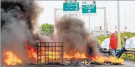  ?? Philippe Huguen
AFP/ Getty I mages ?? A BARRICADE of burning tires blocks access to the Channel Tunnel in Calais, the port in northern France where MyFerryLin­k workers were on strike.