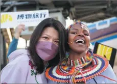  ?? HAN XU / XINHUA ?? A Chinese tourist poses for a photo with a Maasai performer at Jomo Kenyatta Internatio­nal Airport, in Nairobi, on Feb 11.