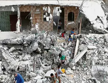  ??  ?? In ruins: Youths checking the remains of the house of a Palestinia­n assailant after it was demolished by Israeli troops in the West Bank village of Deir Abu Mashal, near Ramallah. — AFP