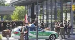  ?? — AFP ?? MUNICH: Police officers secure the area around a commuter rail station in Unterfoehr­ing, where shots were fired yesterday.