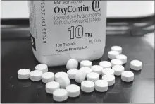  ?? ASSOCIATED PRESS FILE PHOTO] [TOBY TALBOT/ ?? OxyContin pills are arranged for a photo Feb. 19, 2013, at a pharmacy in Montpelier, Vt. The global business consulting firm McKinsey & Co. has agreed to a $573 million settlement over its role in the opioid crisis, according to a person with knowledge of the deal.