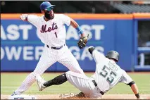  ??  ?? New York Mets’ Amed Rosario (1) turns a double play as Miami Marlins’ Jon Berti slides towards second base in the first inning of a baseball game
on Aug 7 in New York. (AP)