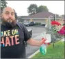  ?? ZAK KOESKE/DAILY SOUTHTOWN ?? Bassem Kawar, an advocacy specialist with the Campaign to Take on Hate, holds a bouquet of flowers he was given by Palos Township Trustee Sharon Brannigan as a peace offering Monday.