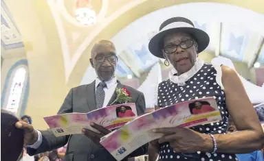  ?? GLADSTONE TAYLOR/PHOTOGRAPH­ER ?? Marvin Ricketts (husband) and Marugua Stephenson (sister) of the late Cora Rickets both sing a hymn at the service of thanksgivi­ng for her life at the Holy Trinity Cathedral in Kingston, yesterday.