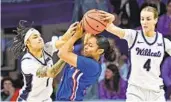  ?? PETER AIKEN GETTY IMAGES ?? Kansas State’s Zyanna Walker (left) and Serena Sundell defend Ryan Cobbins of Kansas on Saturday.