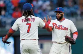 ?? (AP PHOTO/LAURENCE KESTERSON — THE ASSOCIATED PRESS ?? Philadelph­ia Phillies first baseman Carlos Santana congratula­tes third baseman Maikel Franco (7) after they defeated the Pittsburgh Pirates in a baseball game, Saturday.