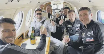  ??  ?? 2 Josh Taylor and his team sip champagne in a private jet on the final leg of their journey home to Scotland