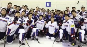  ?? HA SA-HUN, THE ASSOCIATED PRESS ?? South Korean President Moon Jae-in, centre top, poses with South Korean women’s and men’s hockey players at the Jincheon National Training Centre in Jincheon, South Korea, on Wednesday.