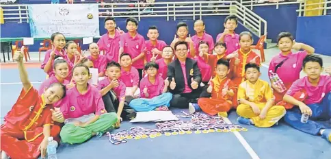  ??  ?? Wong with her athletes who won the inter-division category of the 2nd Wuwang Cup Invitation­al Wushu Championsh­ip at MBKS Indoor Stadium, Kuching last week.