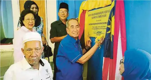  ??  ?? WAN Junaidi (tengah) menandatan­gani plak sebagai simbolik perasmian Dewan Serbaguna Dato Sri Wan Junaidi Kampung Tabuan Lot.