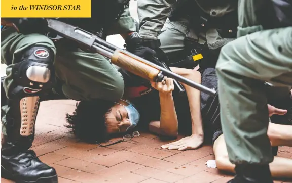  ?? ISAAC LAWRENCE/AFP VIA GETTY IMAGES ?? Pro-democracy protesters are arrested in Hong Kong on Sunday. Beijing is proposing to ban treason, subversion and sedition, and warns it will no longer tolerate dissent.