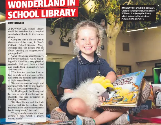  ?? Picture: SHAE BEPLATE ?? IMAGINATIO­N SPARKED: St Clare's Catholic School prep student Eloise Williams, 5, enjoying the library, which features a life-size tree.