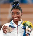  ??  ?? A lone bronze medal was much less than expected but still represente­d a triumph for Simone Biles.