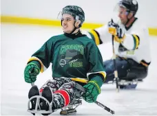  ?? JEFF MCINTOSH/THE CANADIAN PRESS ?? Humboldt Broncos bus crash survivor Ryan Straschnit­zki, left, played in a sledge hockey game in Calgary Saturday alongside Olympian Cassie Campbell-pascall and his dad Tom.