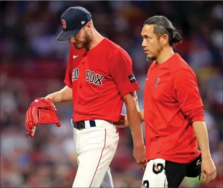  ?? MATT STONE — BOSTON HERALD ?? Red Sox pitcher Chris Sale walks back to the dugout after an apparent injury during the fourth inning of Thursday’s game. Boston’s 8-2 win over Cincinnati was overshadow­ed by Sale’s injury.