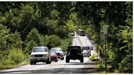  ?? JAY JANNER / AMERICAN-STATESMAN ?? The Red Bud Trail bridges connected by Red Bud Isle are stressed by a daily load of 13,000 cars, some brave cyclists and a few sludge trucks.