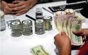  ?? [AP FILE PHOTO] ?? A person buys marijuana at the Essence cannabis dispensary in Las Vegas. Many employers across the country are quietly taking what once would have been a radical step: They’re dropping marijuana from the drug tests they require of prospectiv­e employees.