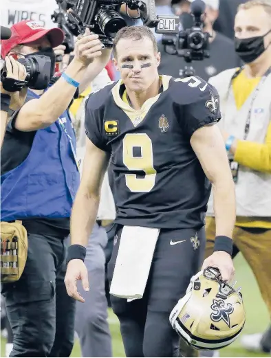  ?? BUTCH DILL/AP ?? Saints quarterbac­k Drew Brees leaves the field after a playoff game against the Buccaneers on Jan. 17 in New Orleans.