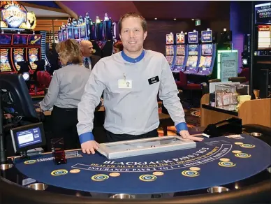  ?? DAVID CROMPTON PHOTOS/Penticton Herald ?? ABOVE: Kevin Muir prepares to man the blackjack table on Wednesday, opening day for Cascades Casino Penticton. RIGHT: A Cascades Casino Penticton employee prepares for a busy opening night at the Match Eatery and Public House. BOTTOM LEFT: Tony Santo,...