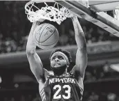  ?? Mark Lennihan / Associated Press ?? Mitchell Robinson scored a career-high 23 points in New York’s 125-115 win against Chicago.