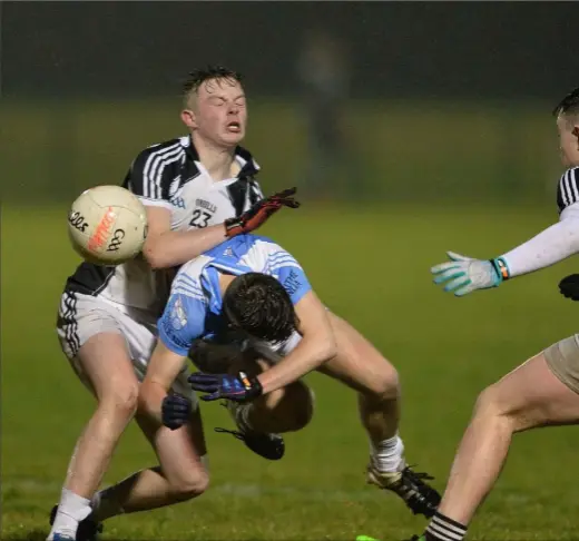  ??  ?? Ben Quaile, Mattock/Hunterstow­n/Glen Emmets combinatio­n feels this challenge from Ronan Levins, Newtown Blues.