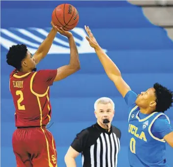  ?? JAYNE KAMIN-ONCEA GETTY IMAGES ?? USC’S Tahj Eaddy (2) lets fly the winning 3-pointer in the last seconds to beat UCLA on Saturday.