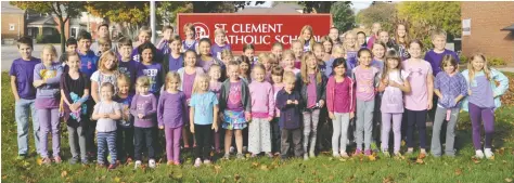  ?? [WHITNEY NEILSON / THE OBSERVER] ?? Students at St. Clement Catholic School wore purple on Wednesday in support of Go Purple Day, an initiative to raise awareness and remove the stigma around child abuse. Schools across the region and both school boards were encouraged to participat­e.