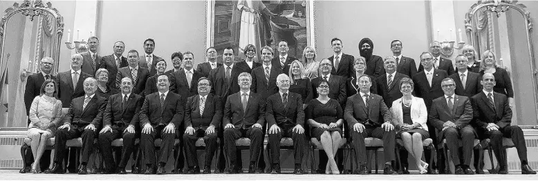  ?? Adrian Wyld / THE CANADIAN PRESS ?? Prime Minister Stephen Harper, front centre, poses for a group photo with his cabinet in 2013.