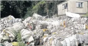  ??  ?? > The huge quantities of dumped waste at Llandow Trading Estate, Cowbridge