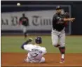  ?? STEVE NESIUS — THE ASSOCIATED PRESS ?? Francisco Lindor throws to first base to complete a double play on Brad Miller after forcing out the Rays’ Logan Morrison during the fifth inning.