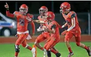  ?? SARAH PHIPPS, THE OKLAHOMAN] [PHOTO BY ?? Carl Albert’s Dadrion Taylor, left, celebrates a touchdown during the Class 5A state championsh­ip game.