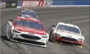  ?? ALEX GALLARDO — THE ASSOCIATED PRESS ?? Ryan Blaney (21) leads Clint Bowyer (14) through turn two during the NASCAR Cup Series auto race at Auto Club Speedway in Fontana March 26.