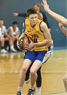  ??  ?? TGS’ Greg Spurgin works under the basket through St Mary’s College defenders.