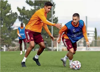  ??  ?? Real Madrid’s Raphael Varane tackles Eden Hazard (right) during a training session ahead of their Champions League match against Inter Milan on Tuesday. — Real Madrid Twitter