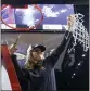  ?? IAN MAULE — ASSOCIATED PRESS ?? USC coach Lindsay Gottlieb cuts down the net after the Trojans won the Pac-12title.