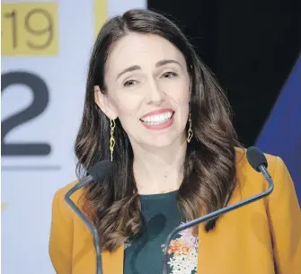  ?? MARK MITCHELL, NEW ZEALAND HERALD VIA AP ?? New Zealand Prime Minister Jacinda Ardern addresses a news conference in Wellington on Monday where she announced New Zealand will drop to COVID-19 alert Level 1.