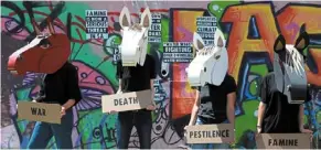  ?? — AP ?? Highlighti­ng food shortage: Members of the Extinction Rebellion’s Four Horse-men of the Climate Apocalypse staging a protest on famine in Cape Town, South Africa, to mark the last official day of COP27.
