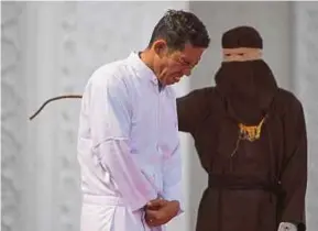  ?? AFP PIC ?? Jono Simbolon grimacing in pain as he is caned in front of a crowd in Aceh on Friday.