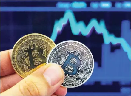  ?? JACK GUEZ/AFP ?? China’s digital currency is likely to be more akin to electronic money, stored on a physical medium, than a cryptocurr­ency such as bitcoin which is based on a computer network.