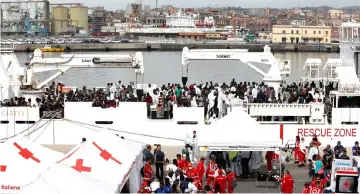  ??  ?? Migrants disembark Italian coast guard vessel ‘Diciotti’ as they arrive at the port of Catania, Italy. — Reuters photo