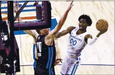  ?? CHASE STEVENS — LAS VEGAS REVIEW-JOURNAL VIA AP ?? The Warriors’ Jonathan Kuminga attempts to score as the Orlando Magic’s Jon Teske defends during a summer league game in Las Vegas.