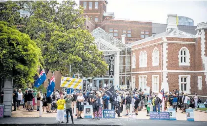  ?? Photo / Michael Craig ?? Protestors gathered outside the High Court in Auckland on Tuesday.
and said