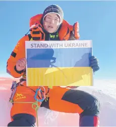  ?? — AFP photo ?? Samoilova posing with a flag at the summit of the Mount Everest in Nepal.