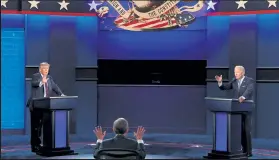  ?? SCOTT OLSON / Getty Images ?? President Donald Trump and Democratic presidenti­al nominee Joe Biden participat­e in the first presidenti­al debate moderated by Fox News anchor Chris Wallace, center, on Tuesday at the Health Education Campus of Case Western Reserve University in Cleveland.